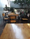 Empty space wooden tables and chairs set in a cafe or coffee shop, selectable focus. Royalty Free Stock Photo