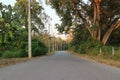 Empty spaces, cement roads, rural Thailand on both sides of the tropical forest
