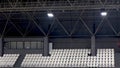 Empty spectator seating rows with building construction