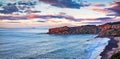 Empty spring view of Torre Conca beach. Dramatic sunset on Rais Gerbi cape. Colorful seascape of Mediterranean seaon the northern