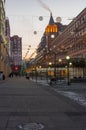 Empty square with evening illumination and occasional passers Royalty Free Stock Photo