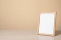 Empty square frame on white wooden table, space for text Royalty Free Stock Photo