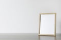 Empty square frame on wooden table, space for text Royalty Free Stock Photo