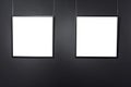 Empty square frames on black brick wall. Blank space posters or art frame waiting to be filled. Square Black Frame Mock-Up Royalty Free Stock Photo