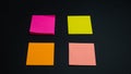 Empty square multi-colored stickers hang on a black board, business concept Royalty Free Stock Photo