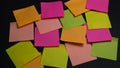 Empty square multi-colored stickers hang on a black board, business concept Royalty Free Stock Photo