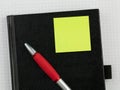 Red notebook, clean white sheet and glases.
