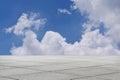 Empty square tile floor boundlessly in blue sky.