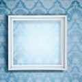 Empty square wooden frame on pale blue floral wallpaper wall background, generative AI