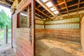 Empty stable in wooden horse barn. Royalty Free Stock Photo