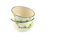 Empty stack beige ceramic bowl with brown rim and green flora pattern isolated on a white background.