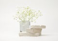 Empty stack of stones and flower platform podium on beige background. Minimal empty display product presentation scene