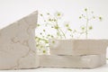 Empty stack of stones and flower platform podium on beige background. Minimal empty display product presentation scene