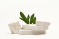 Empty stack of stones and leaf platform podium on beige background. Minimal empty display product presentation scene