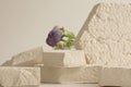 Empty stack of stones platform podium on beige background. Minimal empty display product presentation scene. Selective soft focus