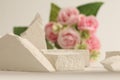 Empty stack of stones platform podium and rose flower bouquet on beige horizontal background. Minimal empty display product