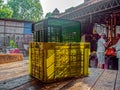 Empty stacks of colorful plastic crates in a farmers produce market