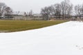 Empty stadium, treadmill, paved, with markings for runner athletes and football field. In winter in snowy