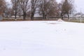 Empty stadium, treadmill, paved, with markings for runner athletes. In winter in snowy