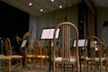 Empty stage with chairs and musical scores before a symphony orchestra performance