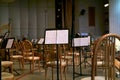 Empty stage with chairs and musical scores before a symphony orchestra performance