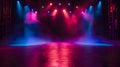 An empty stage is dramatically lit with vibrant blue and purple spotlights Royalty Free Stock Photo