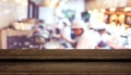 Empty step dark wood table top food stand with blur chef cooking Royalty Free Stock Photo