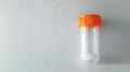 Empty sterile stool sample collection container with orange cap. Medical specimen jar for fecal analysis. Concept of Royalty Free Stock Photo