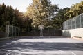 An empty still life of a basketball court on a sunny day with white marking with a hoop and net. A sports ground or Royalty Free Stock Photo