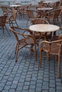 Stone table and wooden chairs of street cafe in evening Royalty Free Stock Photo