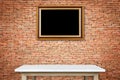 Empty stone table and gold vintage wooden photo frame hang on th Royalty Free Stock Photo