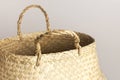 Empty straw wicker basket on a gray background. Fashionable bamboo basket, stylish interior item, eco design, handmade. Natural Royalty Free Stock Photo