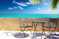 empty street bar, cafe or restaurant with an old wrought iron table and chairs standing near a colonial stone wall overlooking Royalty Free Stock Photo