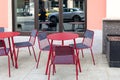 Empty street cafe. Red metal tables and chairs Royalty Free Stock Photo