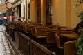 Empty Street Cafe With Wicker Chairs On A Rainy Evening In The City