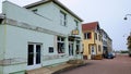 Empty street with colorful buildings and a couple of parked cars. Saint Pierre and Miquelon.