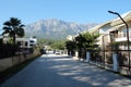 Empty street in Kemer city and Taurus mountains at far on a bright sunny day