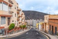 Empty street in La Laguna town with a car driving down an asphalt road Royalty Free Stock Photo