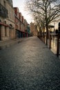 Empty street in La rochelle at evening. Saint Nicolas Tower in the background