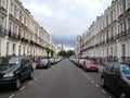An empty street in London city with cars parked