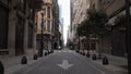 An empty street because of quarantine in the old city of Argentina. sky. street light. flag. doves. palms . clouds. trees. Royalty Free Stock Photo