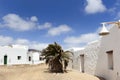 Empty street with sand and white houses in Caleta de Sebo on the island La Graciosa