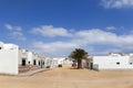 Empty street with sand and white houses in Caleta de Sebo on the island La Graciosa