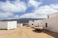 Empty street with sand and white houses in Caleta de Sebo on the island La Graciosa