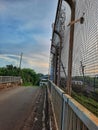 an empty street was bridged with an iron fence on its side