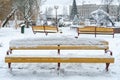 Empty streets without people after a snowfall. Empty park benches are covered in snow. Infrastructure is paralyzed due to a snow