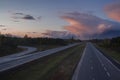 An empty stretch of the 401 highway in Ontario, Canada with a distant storm Royalty Free Stock Photo