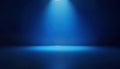 Empty studio with gradient blue background. Spotlight illuminates center. Blank space suitable for products. Stylish interior Royalty Free Stock Photo