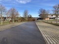 Empty suburban road under a blue sky