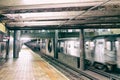 Empty subway station with speeding up train in New York City Royalty Free Stock Photo